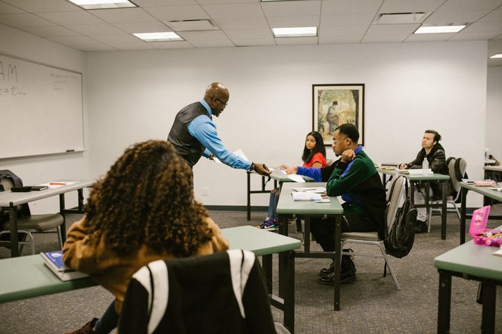 An instructor leading a hands-on training workshop with a small group