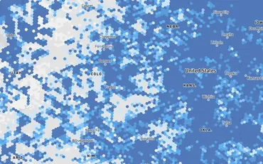 The FCC National Broadband Map zoomed into the central states, each hexagonal cell shaded by the share of units served, from white through to deep blue.